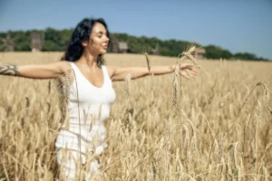 A woman standing in a field of wheat