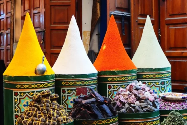 Colorful spices displayed in conical piles at a market.