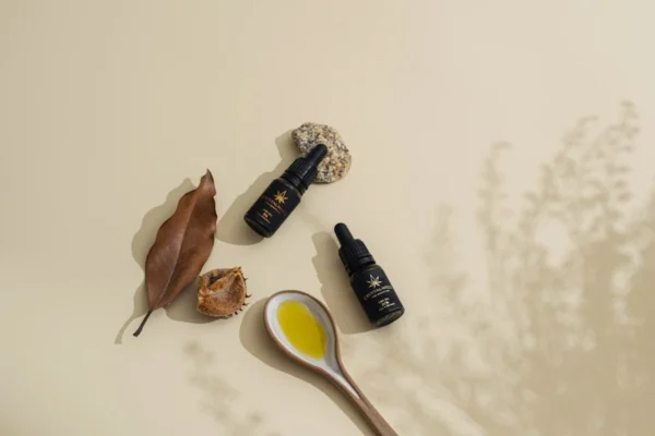 a spoon with a yellow liquid next to some leaves