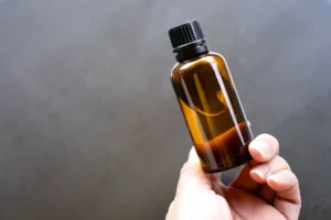 Hand holding amber glass bottle