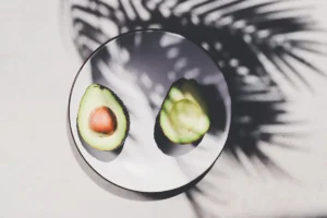 An avocado cut in half on a plate