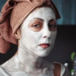 shallow focus photography of woman having a facial