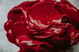 a close up of a red substance on a white surface